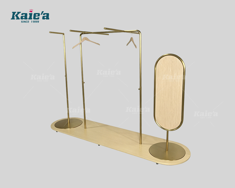 Wood and gold-colored stainless steel clothing display stand