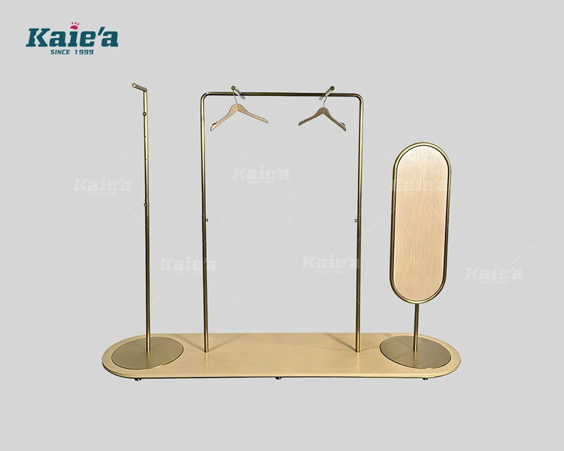 Wood and gold-colored stainless steel clothing display stand