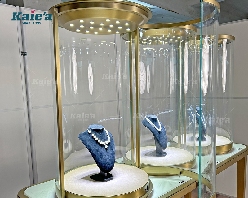 Luxurious jewelry display table with cylindrical glass display cabinets